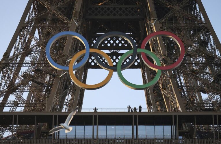 Paris Olympics organizers unveil a display of the five Olympic rings mounted on the Eiffel Tower